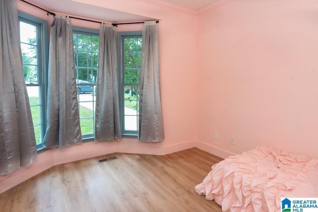 1004 Broken Bow Trl, Alabaster, AL 35007 - unfurnished bedroom with wood finished floors and crown molding