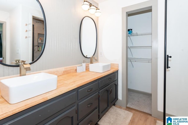 1004 Broken Bow Trl, Alabaster, AL 35007 - bathroom with wood finished floors, double vanity, and a walk in closet