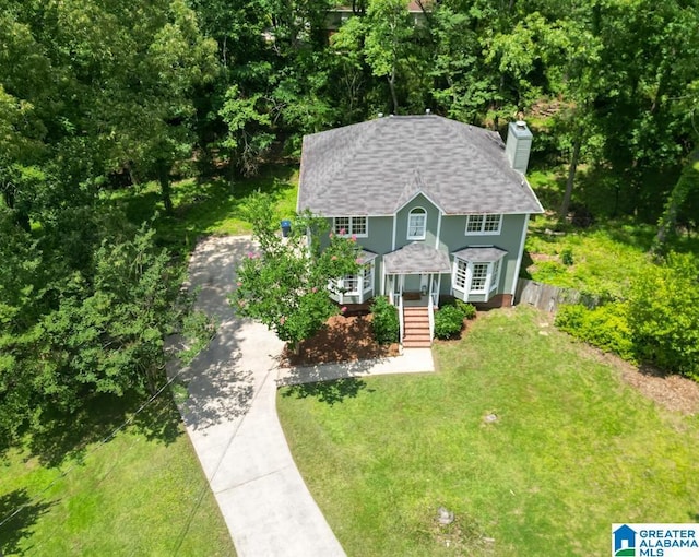 1004 Broken Bow Trl, Alabaster, AL 35007 - view of front of property featuring concrete driveway, a chimney, a front lawn, roof with shingles, and a porch