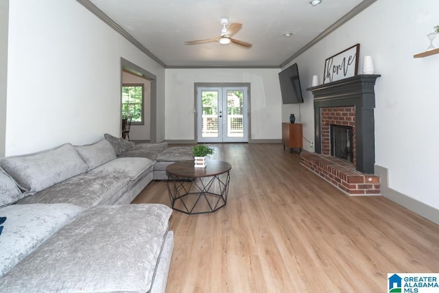 1004 Broken Bow Trl, Alabaster, AL 35007 - living area with ornamental molding, wood finished floors, a ceiling fan, a brick fireplace, and french doors