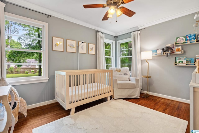 4317 Warren Rd, Birmingham, AL 35213 - bedroom with wood finished floors, ornamental molding, a crib, and ceiling fan