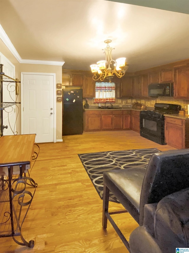 1545 Carol Cir, Midfield, AL 35228 - living area featuring a chandelier, ornamental molding, and light wood finished floors