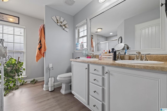955 Clover Ave, Odenville, AL 35120 - bathroom featuring double vanity, a shower stall, and wood finished floors