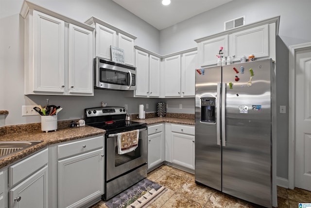 955 Clover Ave, Odenville, AL 35120 - kitchen with stainless steel appliances, white cabinets, recessed lighting, and light tile patterned flooring