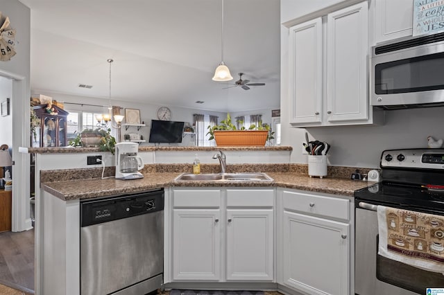 955 Clover Ave, Odenville, AL 35120 - kitchen featuring appliances with stainless steel finishes, a ceiling fan, white cabinets, hanging light fixtures, and a chandelier