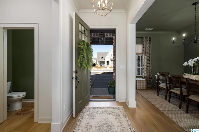 1313 Severn Way, Hoover, AL 35244 - entrance foyer featuring a chandelier, ornamental molding, and light wood finished floors