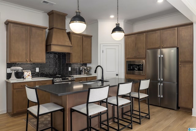 1313 Severn Way, Hoover, AL 35244 - kitchen with stainless steel appliances, custom exhaust hood, tasteful backsplash, ornamental molding, and light wood-style floors