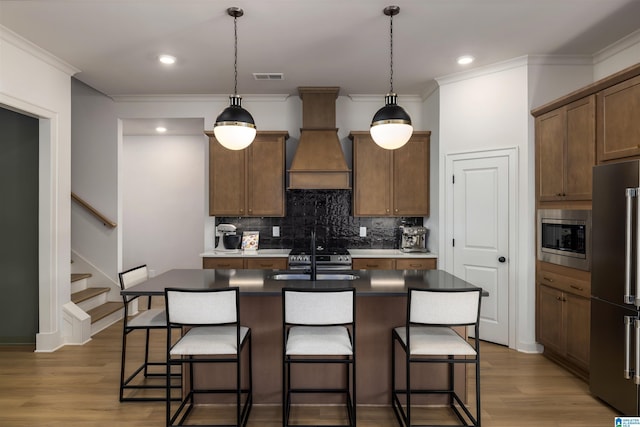 1313 Severn Way, Hoover, AL 35244 - kitchen featuring appliances with stainless steel finishes, crown molding, decorative backsplash, a breakfast bar, and light wood-style floors