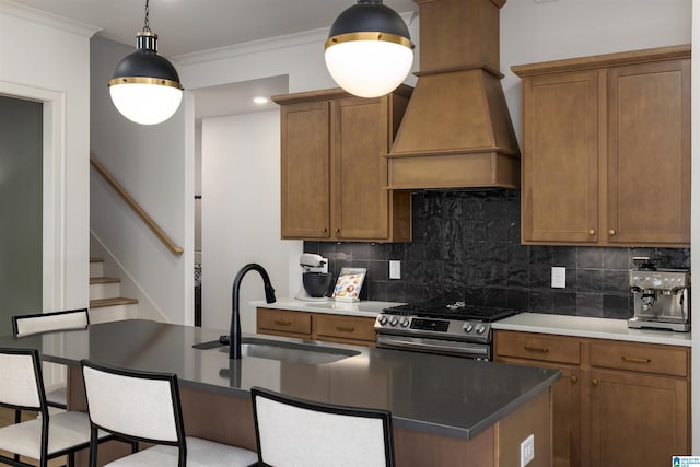 1313 Severn Way, Hoover, AL 35244 - kitchen featuring gas range, custom range hood, brown cabinetry, tasteful backsplash, and hanging light fixtures