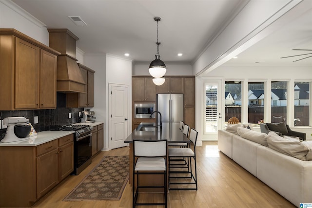 1313 Severn Way, Hoover, AL 35244 - kitchen with stainless steel appliances, decorative backsplash, light wood-style floors, open floor plan, and ornamental molding