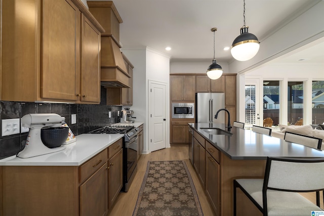 1313 Severn Way, Hoover, AL 35244 - kitchen featuring appliances with stainless steel finishes, custom range hood, tasteful backsplash, a kitchen island with sink, and light wood-style flooring