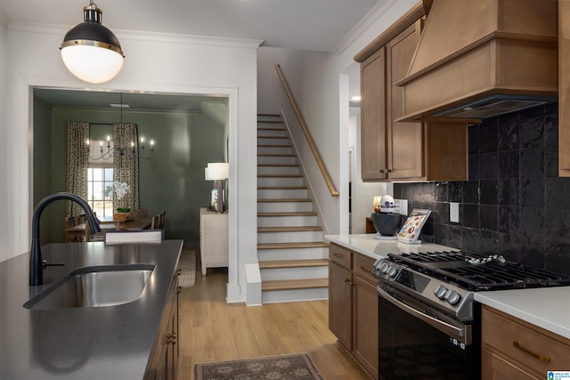 1313 Severn Way, Hoover, AL 35244 - kitchen with stainless steel range with gas cooktop, custom exhaust hood, a chandelier, light wood finished floors, and tasteful backsplash