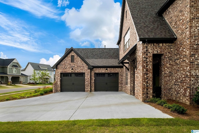 1313 Severn Way, Hoover, AL 35244 - view of property exterior with a garage, brick siding, concrete driveway, and roof with shingles