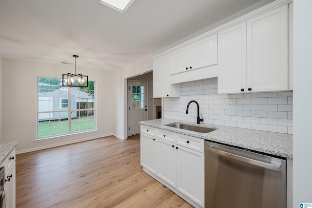4022 Cambridge Dr, Moody, AL 35004 - kitchen with stainless steel dishwasher, decorative backsplash, light wood-style flooring, and white cabinets