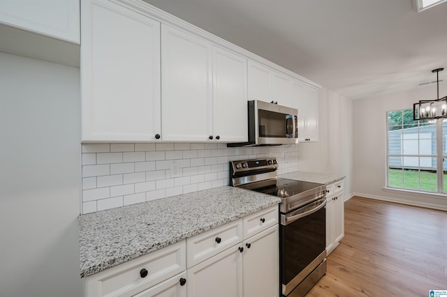 4022 Cambridge Dr, Moody, AL 35004 - kitchen with appliances with stainless steel finishes, tasteful backsplash, light wood finished floors, white cabinets, and light stone counters