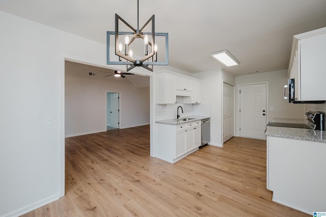 4022 Cambridge Dr, Moody, AL 35004 - kitchen with appliances with stainless steel finishes, decorative backsplash, a chandelier, white cabinetry, and light wood finished floors