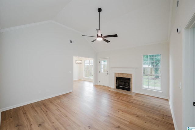 4022 Cambridge Dr, Moody, AL 35004 - unfurnished living room featuring a ceiling fan, a tiled fireplace, light wood finished floors, high vaulted ceiling, and crown molding