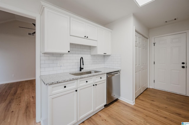 4022 Cambridge Dr, Moody, AL 35004 - kitchen featuring stainless steel dishwasher, light wood-style flooring, and white cabinetry