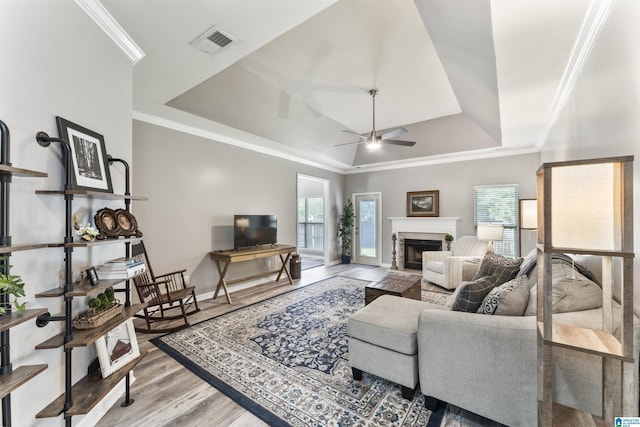 4114 Jubilee Ln, Moody, AL 35004 - living room with a raised ceiling, wood finished floors, a ceiling fan, a fireplace, and ornamental molding