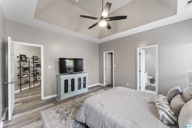4114 Jubilee Ln, Moody, AL 35004 - bedroom with a tray ceiling, wood finished floors, ensuite bathroom, and ceiling fan