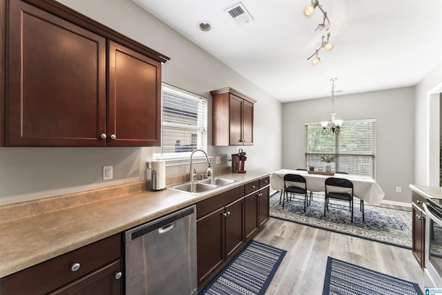 4114 Jubilee Ln, Moody, AL 35004 - kitchen with stainless steel dishwasher, light wood-style flooring, a chandelier, hanging light fixtures, and light countertops