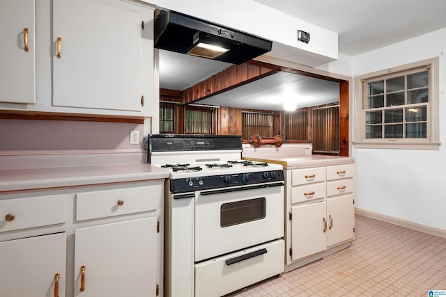 805 Vanderbilt St, Birmingham, AL 35206 - kitchen with white gas range, ventilation hood, light countertops, and white cabinetry