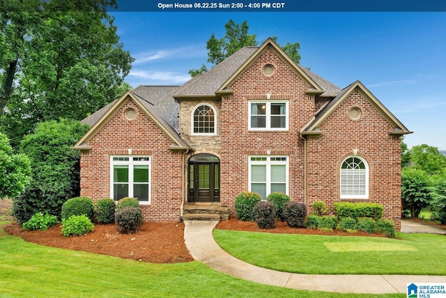 5012 Lake Crest Cir, Hoover, AL 35226 - view of front of home with brick siding, a front yard, and roof with shingles