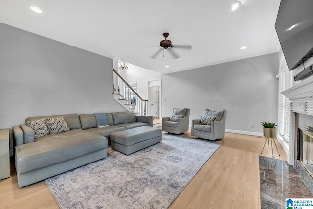 5012 Lake Crest Cir, Hoover, AL 35226 - living room with stairway, ceiling fan, a premium fireplace, wood finished floors, and crown molding