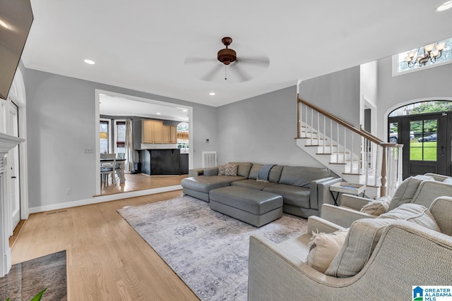 5012 Lake Crest Cir, Hoover, AL 35226 - living room featuring healthy amount of natural light, stairs, light wood-style flooring, a ceiling fan, and recessed lighting