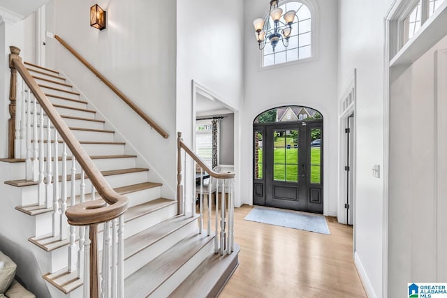 5012 Lake Crest Cir, Hoover, AL 35226 - entrance foyer with healthy amount of natural light, stairway, light wood finished floors, a towering ceiling, and a chandelier