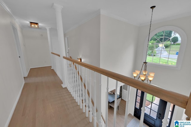 5012 Lake Crest Cir, Hoover, AL 35226 - hall featuring an upstairs landing, a chandelier, crown molding, and light wood-style flooring