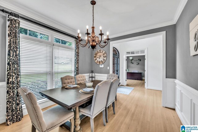 5012 Lake Crest Cir, Hoover, AL 35226 - dining area featuring a chandelier, wainscoting, crown molding, light wood-type flooring, and a decorative wall