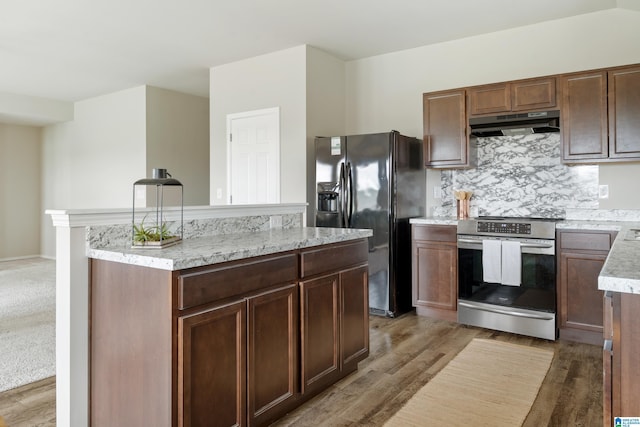 240 Hillcrest Dr, Montevallo, AL 35115 - kitchen with stainless steel electric stove, under cabinet range hood, black fridge with ice dispenser, a center island, and light wood-type flooring