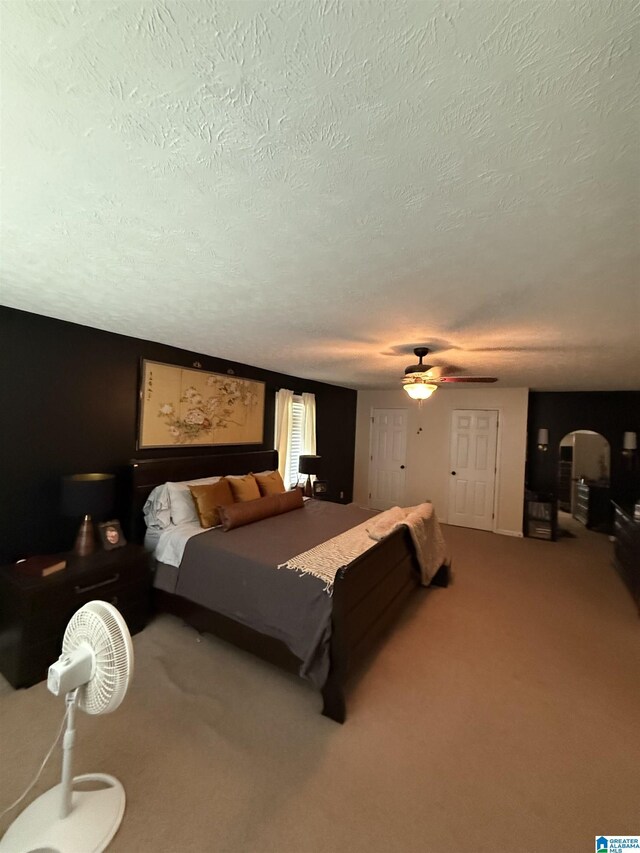 1500 Rockview Cir, Weaver, AL 36277 - bedroom with arched walkways, a textured ceiling, carpet flooring, and a ceiling fan
