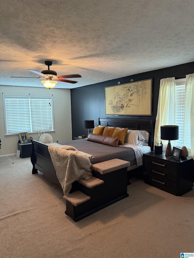 1500 Rockview Cir, Weaver, AL 36277 - carpeted bedroom featuring multiple windows, a textured ceiling, and ceiling fan