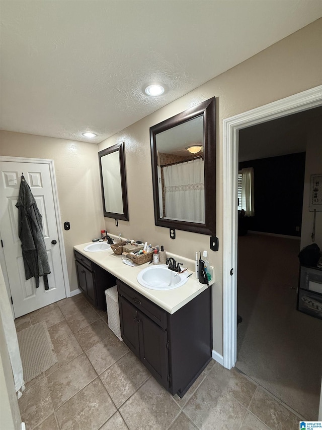 1500 Rockview Cir, Weaver, AL 36277 - bathroom with double vanity, a textured ceiling, tile patterned floors, and recessed lighting