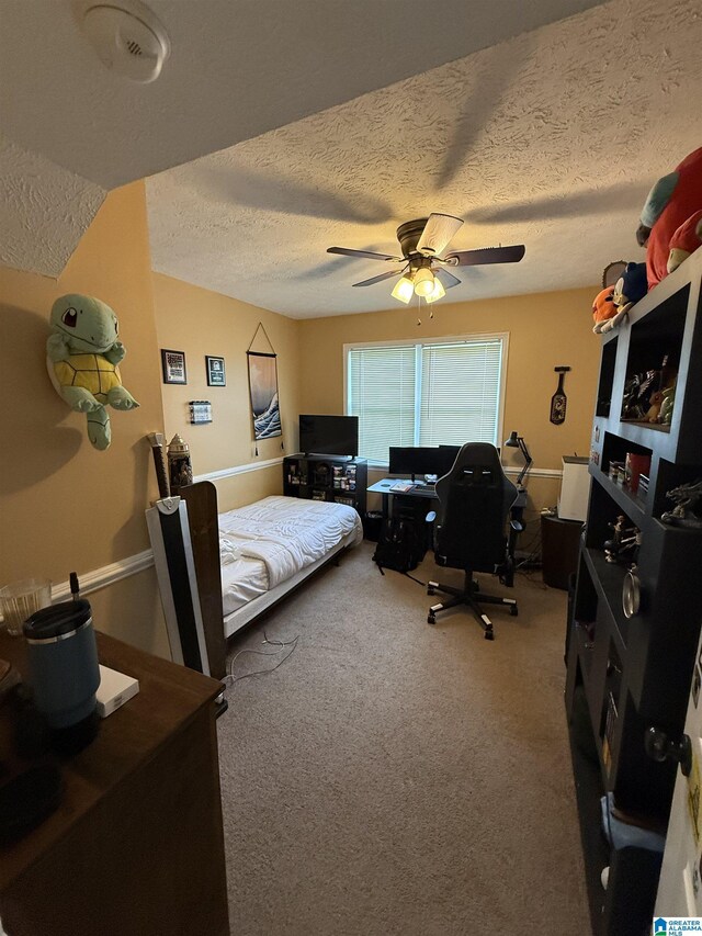 1500 Rockview Cir, Weaver, AL 36277 - bedroom featuring a textured ceiling, carpet flooring, ceiling fan, and a desk