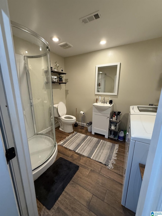 1500 Rockview Cir, Weaver, AL 36277 - bathroom featuring washer and dryer, vanity, a shower stall, wood finished floors, and recessed lighting
