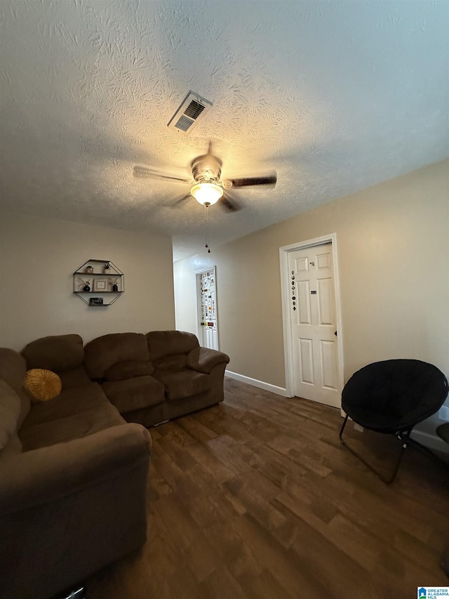 1500 Rockview Cir, Weaver, AL 36277 - living area with ceiling fan, dark wood finished floors, and a textured ceiling