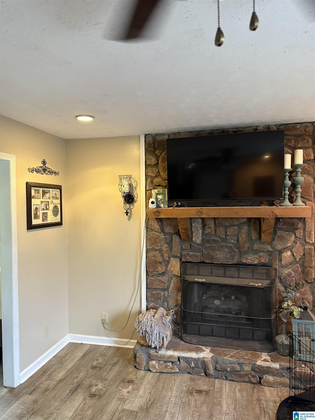 1500 Rockview Cir, Weaver, AL 36277 - unfurnished living room featuring wood finished floors and a stone fireplace