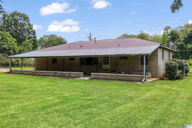 1257 Hueytown Rd, Hueytown, AL 35023 - back of house featuring covered porch, a lawn, brick siding, and a metal roof