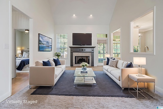 148 Grande View Ln, Alabaster, AL 35114 - living area with lofted ceiling, a tiled fireplace, and wood finished floors