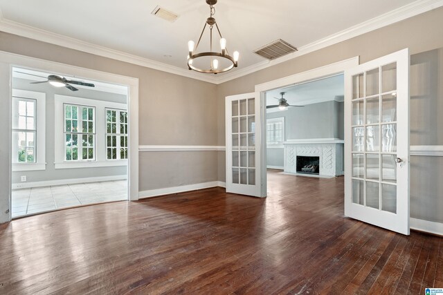1701 S 16th Ave, Birmingham, AL 35205 - empty room with ceiling fan, french doors, wood-type flooring, ornamental molding, and a chandelier