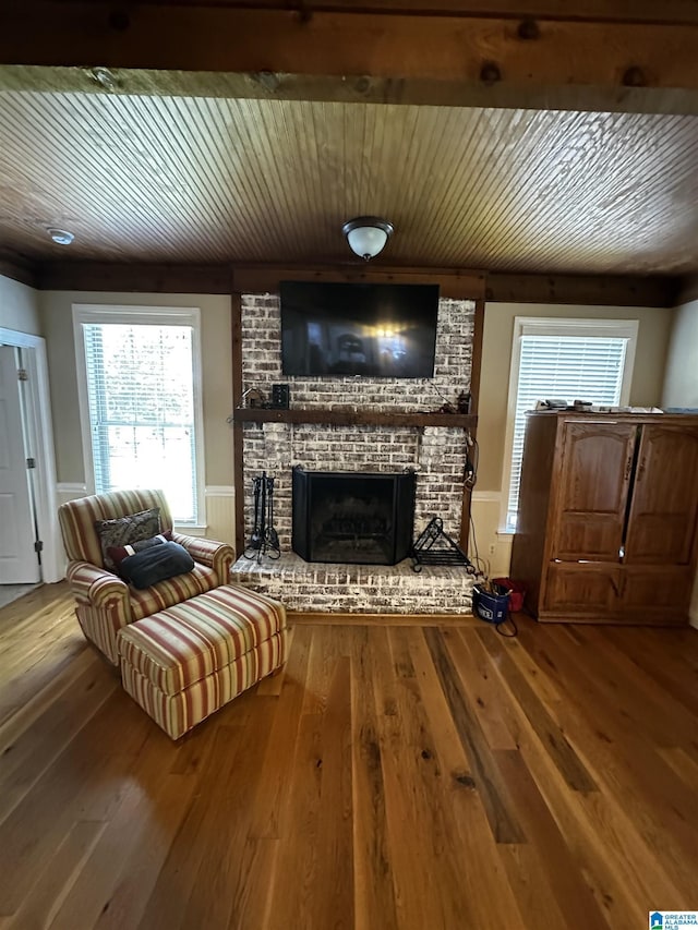 76 Goggins Dr, Montevallo, AL 35115 - living area with wooden ceiling, a fireplace, hardwood / wood-style flooring, and a wainscoted wall