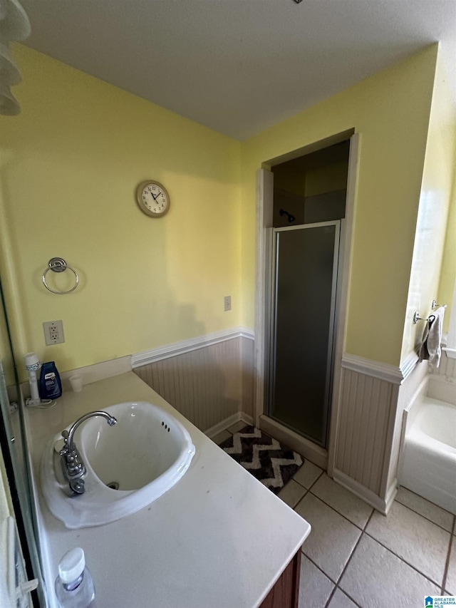 76 Goggins Dr, Montevallo, AL 35115 - bathroom with a wainscoted wall, a shower stall, vanity, a garden tub, and tile patterned floors