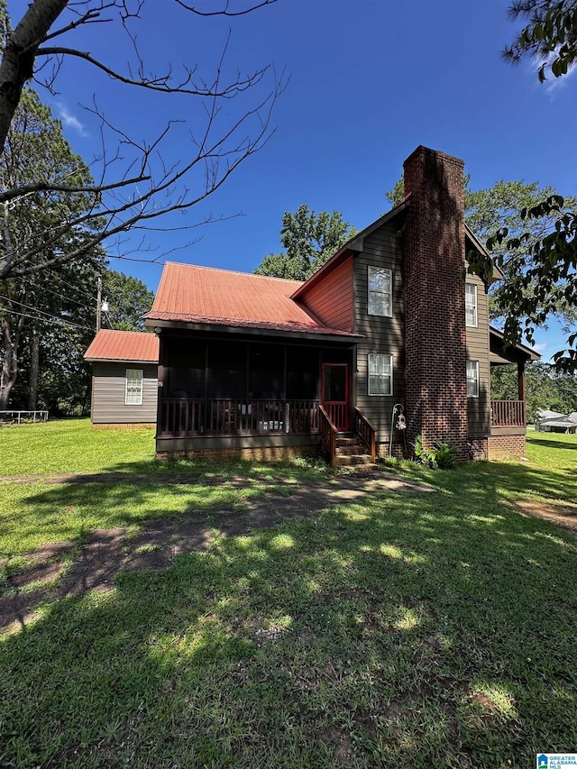 76 Goggins Dr, Montevallo, AL 35115 - rear view of property featuring a sunroom, a yard, and a metal roof
