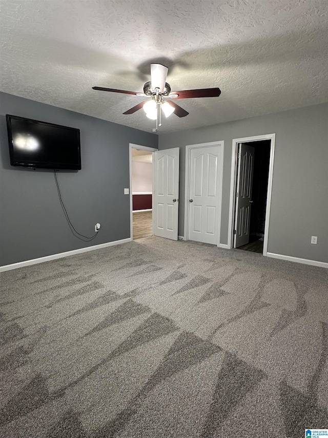 426 Bailey Rd, Weaver, AL 36277 - unfurnished bedroom with a textured ceiling, carpet flooring, and ceiling fan