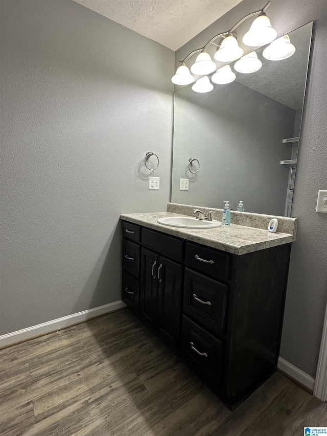 426 Bailey Rd, Weaver, AL 36277 - bathroom with vanity, wood finished floors, and a textured ceiling