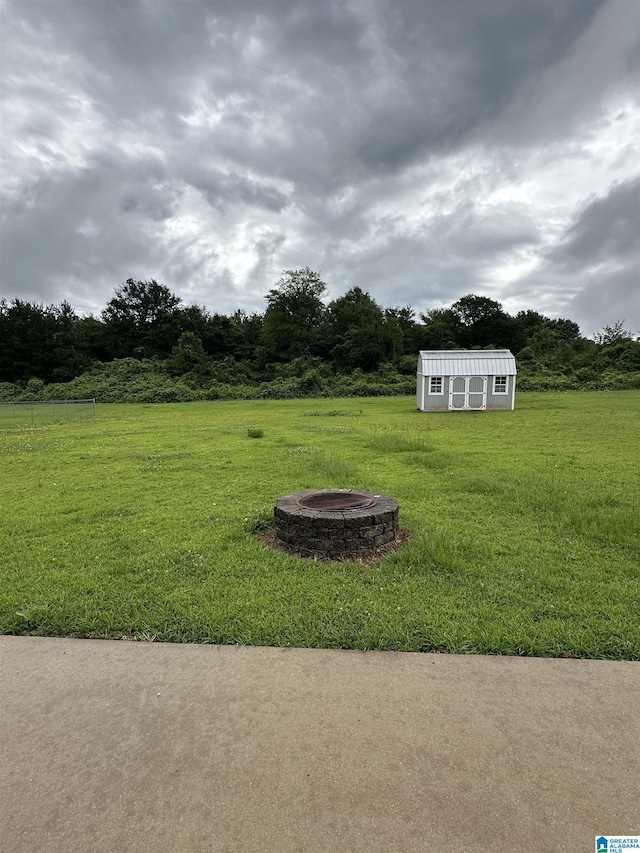 426 Bailey Rd, Weaver, AL 36277 - view of grassy yard with a fire pit and a storage unit