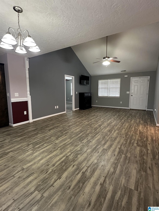 426 Bailey Rd, Weaver, AL 36277 - unfurnished living room featuring ceiling fan, dark wood-type flooring, vaulted ceiling, a textured ceiling, and a chandelier